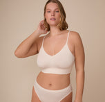 Front-facing image of model Sonnie wearing the Cloud Cotton Triangle Bralette in Quartz. The photo captures the flattering V-neckline and soft, breathable cotton blend. sizing: Sonnie wears size XL