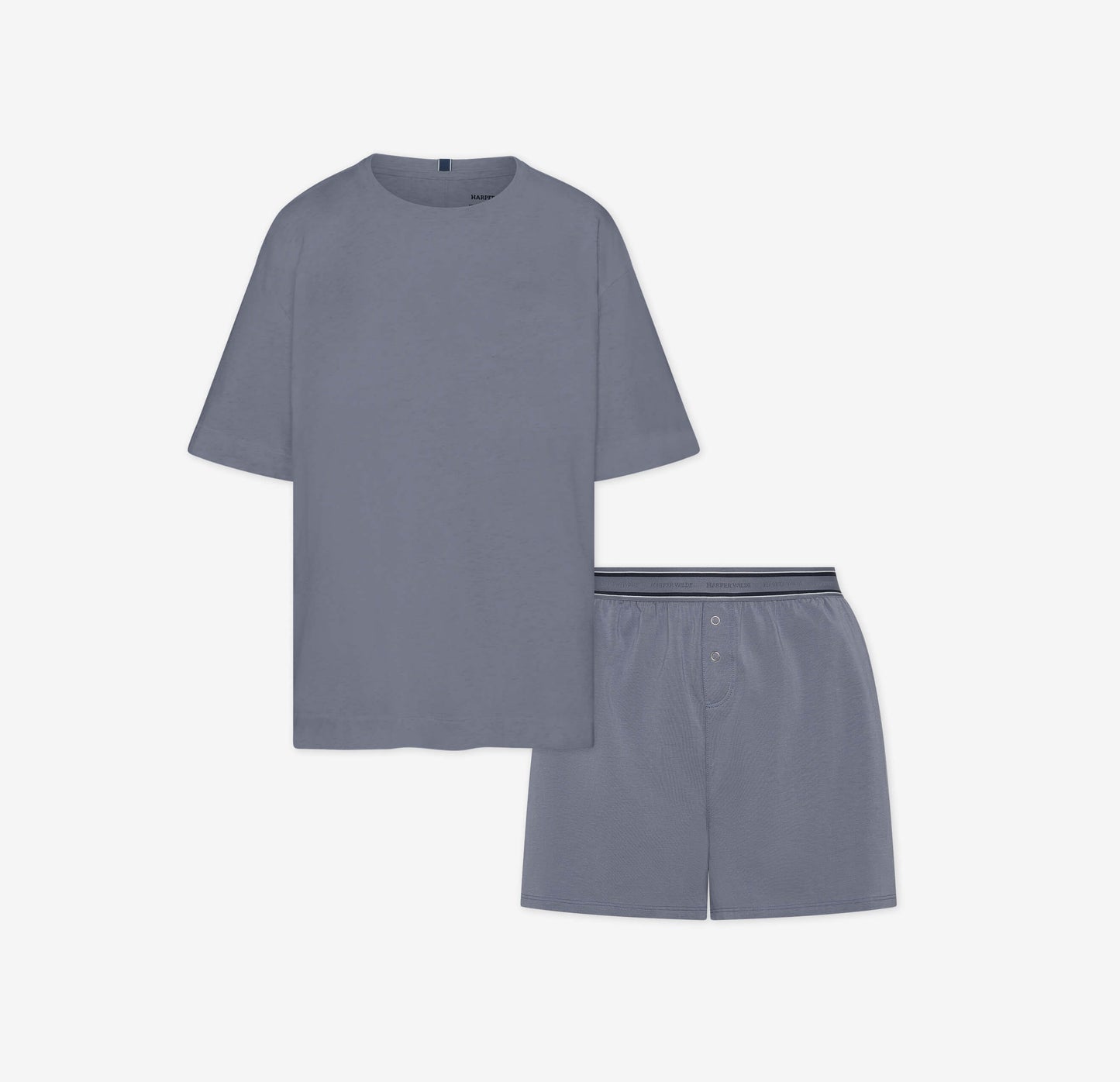 Flat lay of the Cloud Cotton Sleep Set in Slate, featuring a short-sleeve tee with chest pocket and matching boxer-style sleep shorts. The shorts have a button fly and tonal waistband with a thin black stripe detail. Displayed against a white background for a clean, minimal presentation.