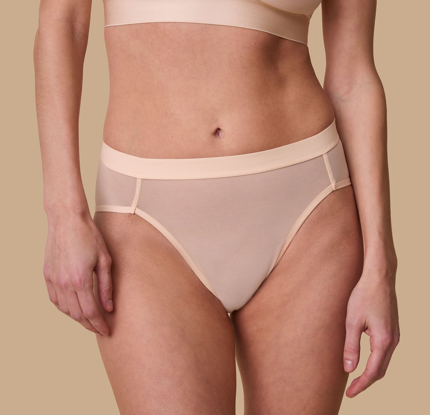 Front close-up view of the ComfortMesh™ Highwaist Brief in Pearl on a second model. The sleek waistband and flattering seams provide a polished and comfortable look.