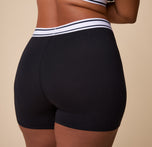 Detail shot of the soft, breathable fabric and the striped elastic waistband on the Cloud Cotton Retro Boxer Brief in Black.