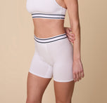 Three quarter angle of Gracie wearing the Cloud Cotton Retro Boxer Brief in White – The image focuses on the stretch and fit of the fabric, highlighting the boxer brief’s flexibility and coverage.