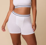 Front view of India wearing the Cloud Cotton Retro Boxer Brief in White – The soft, stretchy fabric contours naturally to the body, providing full coverage and comfort. sizing: India wears size Large