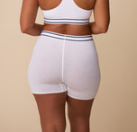 Back view of India in the Cloud Cotton Retro Boxer Brief in White – This shot showcases the smooth design from behind, with the elastic waistband adding a sporty touch.