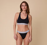 Full-body shot of Gracie in the Harper Wilde Cloud Cotton Retro French Cut Bikini in Black, showcasing the sporty yet comfortable fit of the set.