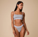 Full-body shot of Ally wearing the Cloud Cotton Retro French Cut Bikini in Heather Charcoal, paired with the matching Bandeau Bralette, standing in a relaxed pose.