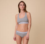 Full-body shot of Gracie modeling the Cloud Cotton Retro Hiphugger in Heather Charcoal with the matching Racerback Bralette.