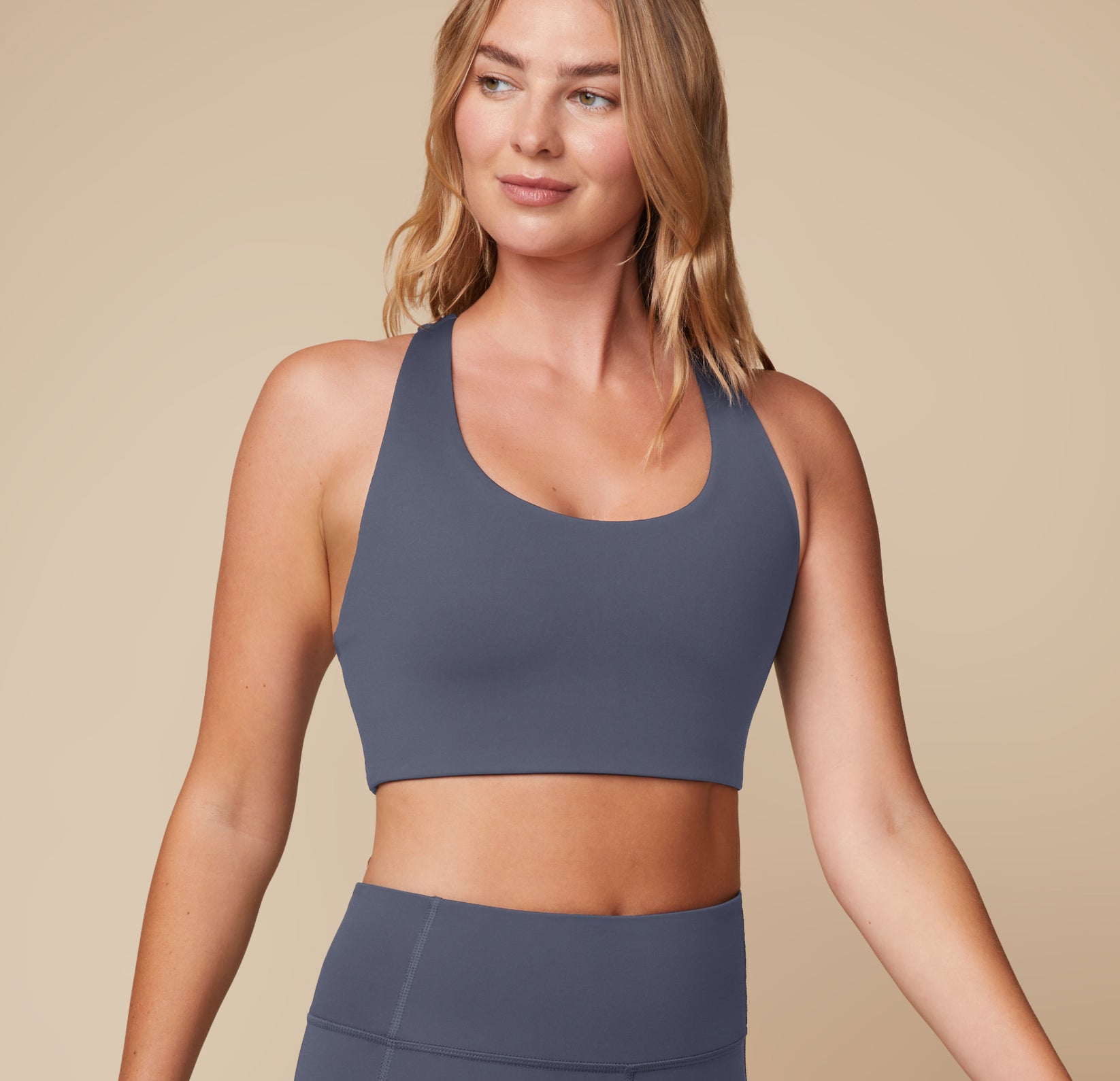 Megan wearing the Flex Convertible Sports Bra in Slate, emphasizing the smooth fabric and supportive design.