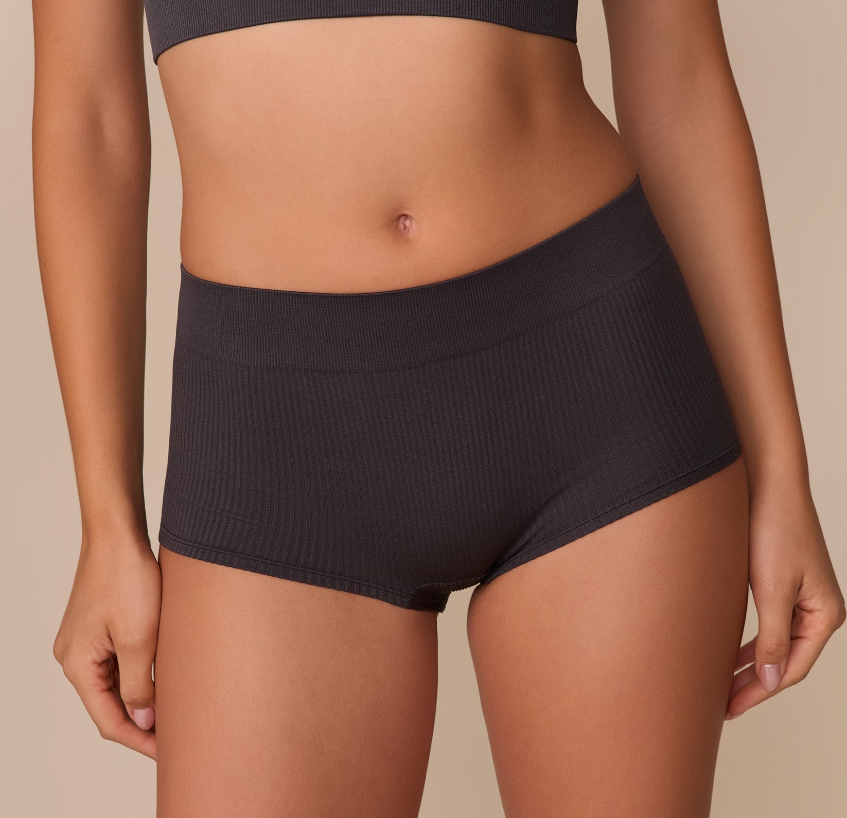 Front-facing close-up of the Lounge Rib Boyshort in Charcoal, emphasizing the flat seams and ribbed texture that give a cozy yet structured look and feel.