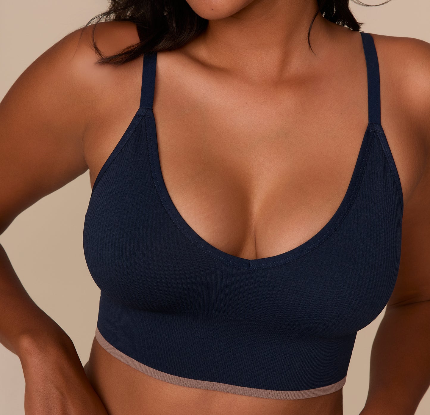 Close-up of Victoria in the Lounge Rib Triangle Bralette in True Blue, focusing on the fabric texture, neckline, and adjustable strap detail. The stretch rib knit and contrast underband are highlighted to show construction quality.