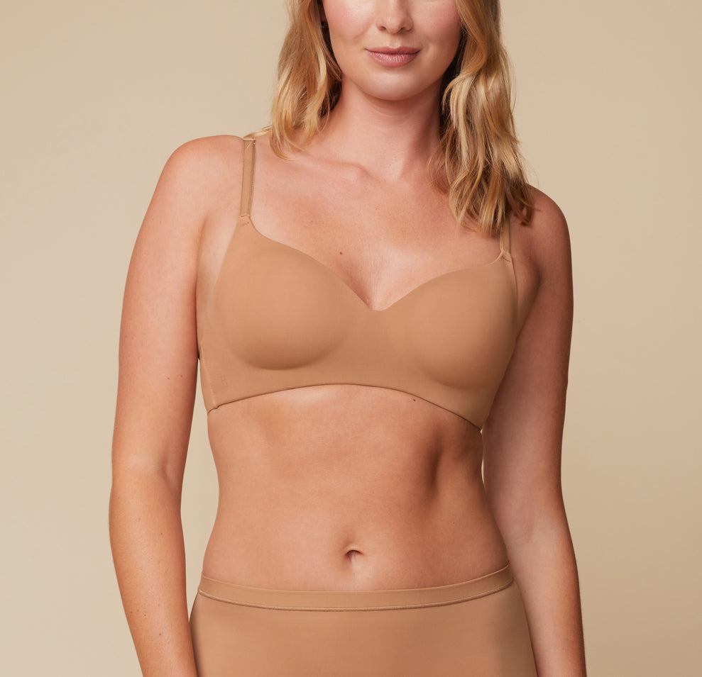 Front view of Megan wearing the Base Wirefree T-Shirt Bra in Tan. The bra features a molded cup design for a smooth, supportive fit, paired with the matching Bliss Boyshort. Adjustable straps ensure a customizable fit. sizing: Megan wears size 36C