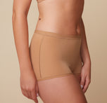 Side profile of model Megan in the Bliss Boyshort in Tan, highlighting the Bliss fabric that provides soft, full coverage. sizing: Megan wears size Medium