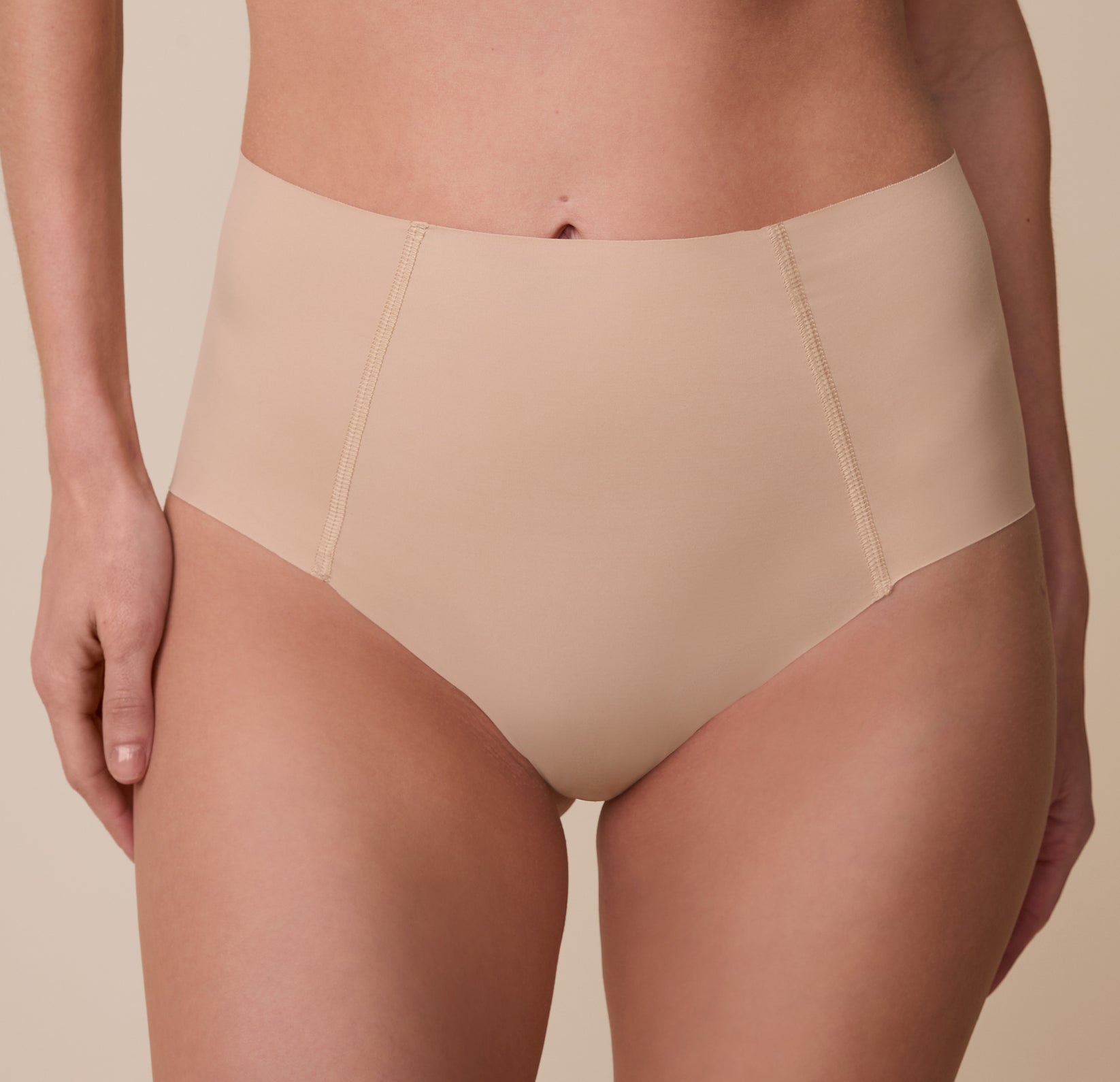 A close-up of the No-Show Highwaist Brief in Beige, showcasing the raw-edge finish and soft, stretchy fabric.