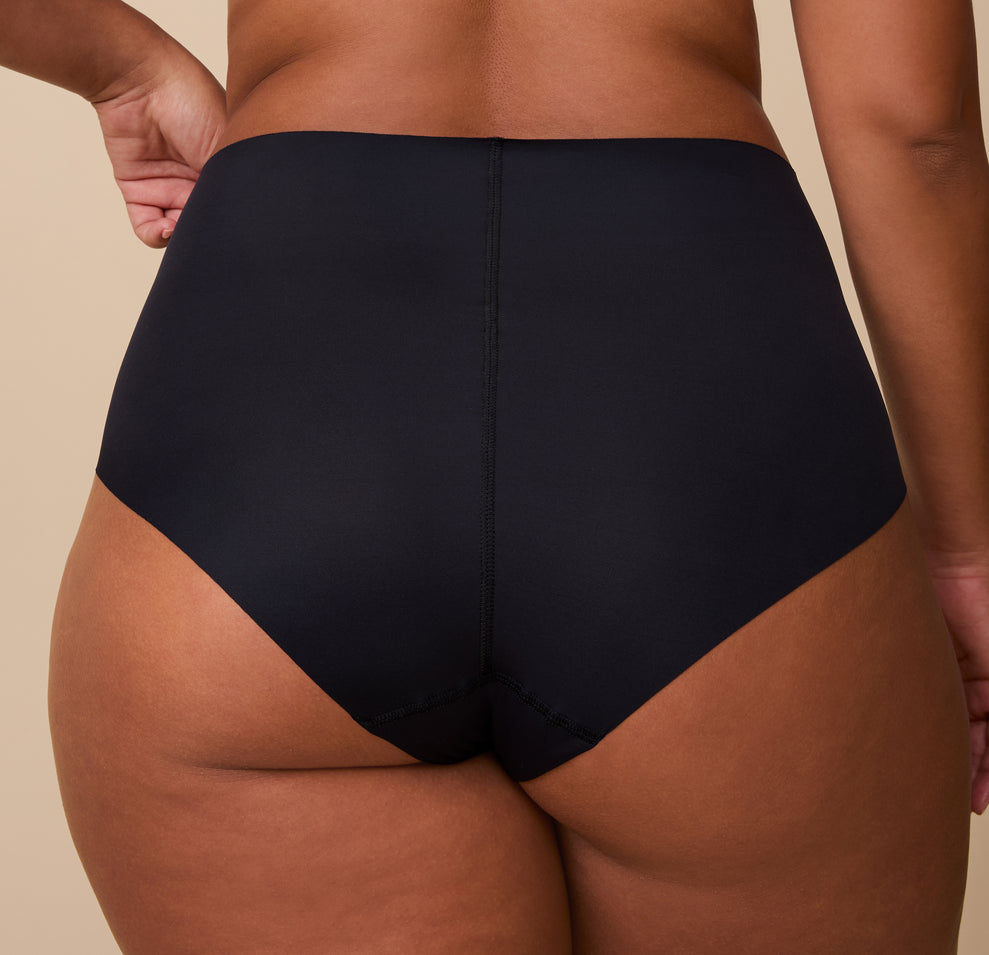 India is shown from behind in a detailed, up-close shot, highlighting the full-coverage back and raw-cut edges for a sleek, no-show finish.