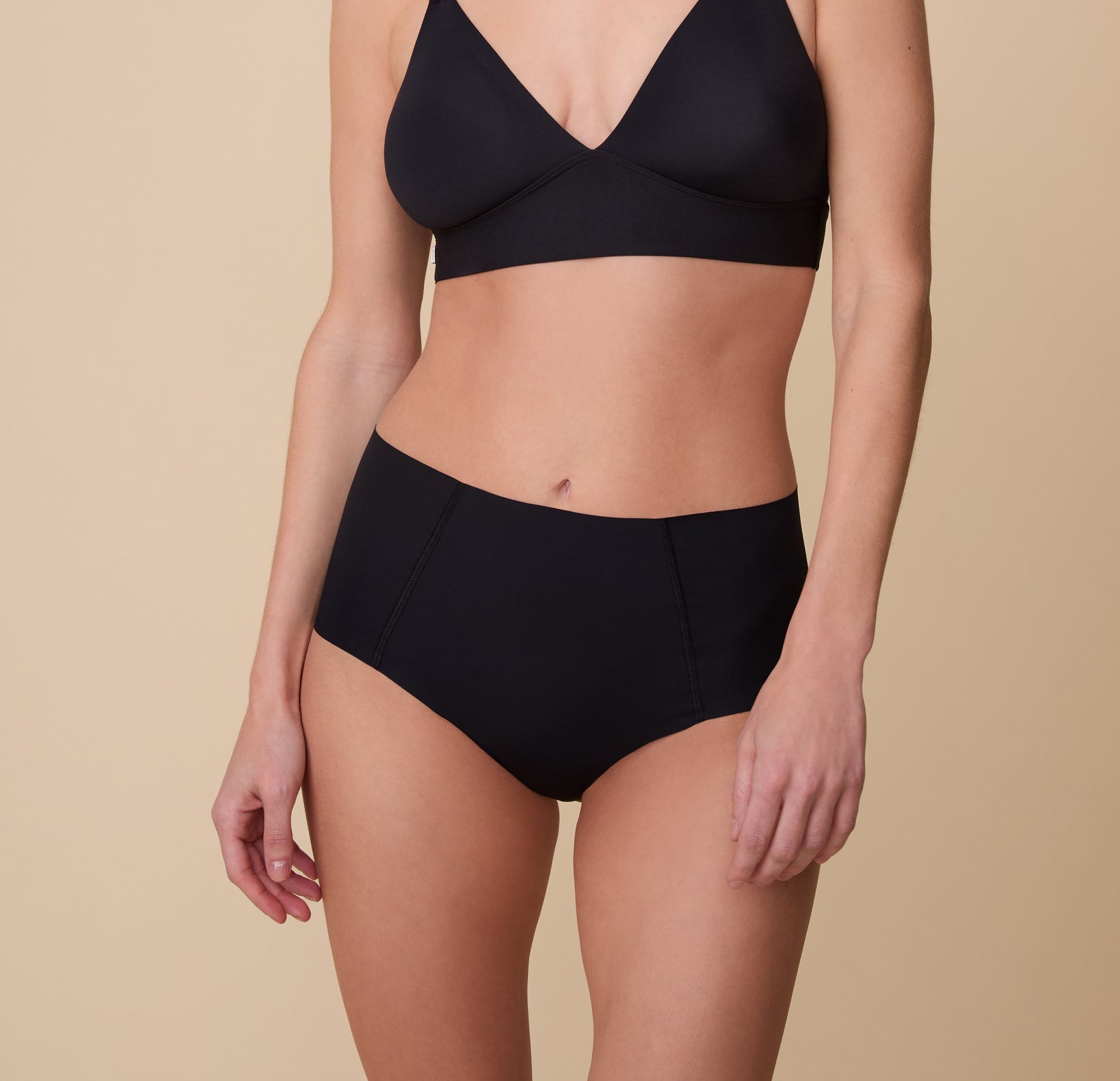 Gracie wearing the No-Show Highwaist Brief in Black with the matching Bliss Triangle Bralette, highlighting its sleek, second-skin fit and high-rise silhouette. sizing: Gracie wears size Small