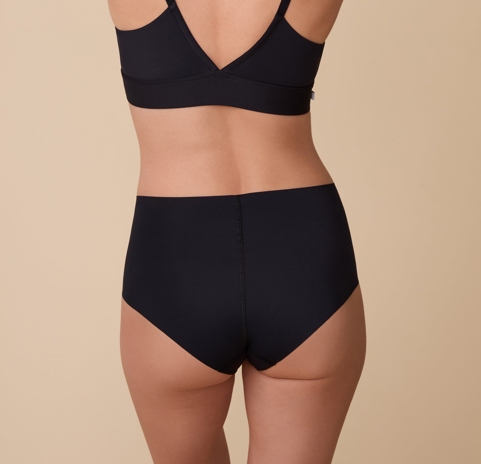 A back view of Gracie in the No-Show Highwaist Brief, showing its seamless construction and curve-hugging fit.