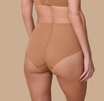 Gracie is shown from behind, highlighting the brief’s full-coverage back and raw-cut edges that lay flat for a no-show look.