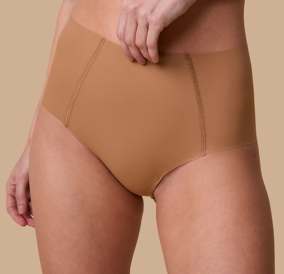 A close-up of the No-Show Highwaist Brief in Tan, showcasing the raw-edge finish and lightweight, barely-there feel.