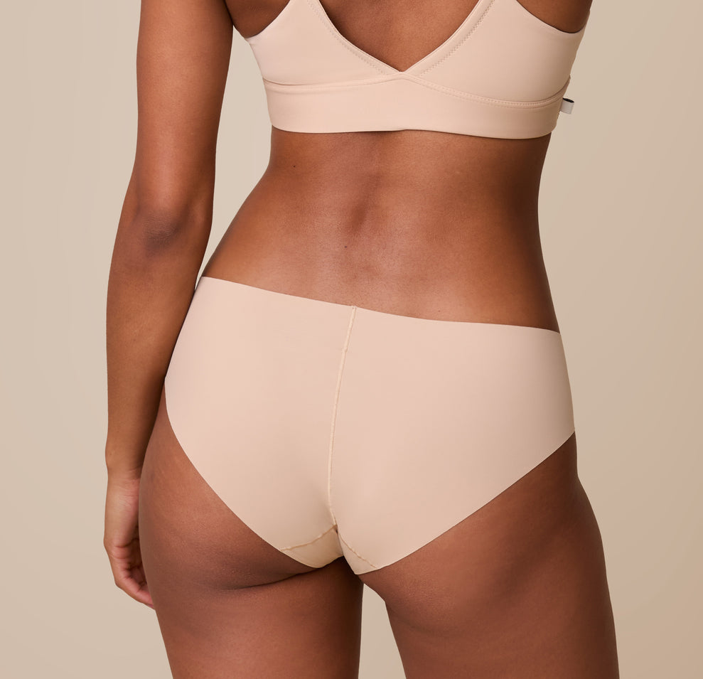 A back view of Ally in the No-Show Hiphugger, showing its seamless construction and curve-hugging fit.