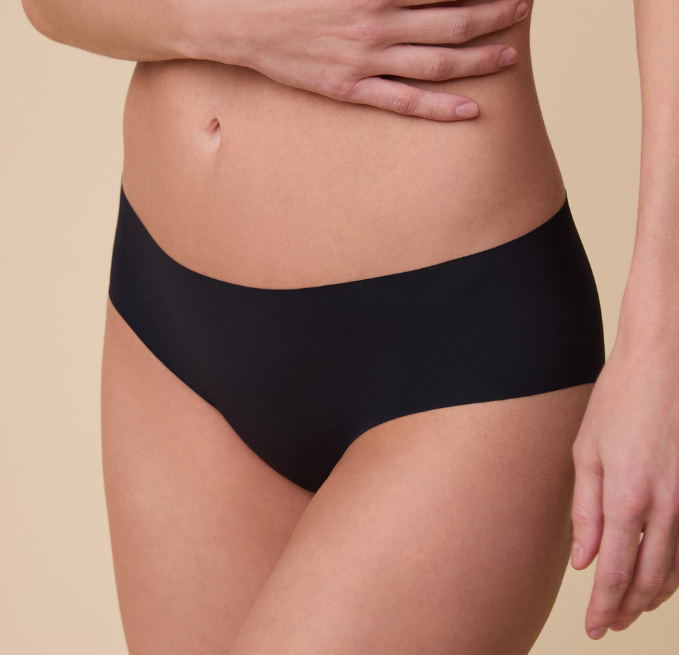 A zoomed-in view of the No-Show Hiphugger in Black on Gracie, emphasizing the smooth, seamless construction and comfortable waistband.