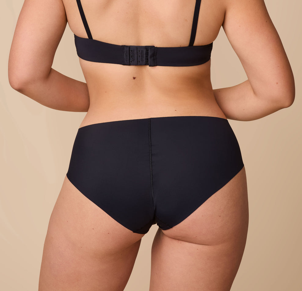 A closer look at the back of the No-Show Hiphugger in Black, showcasing the seamless design, silky fabric, and medium coverage.
