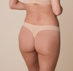 Close-up of the back of the No-Show Thong in Beige on Gracie. The seamless design eliminates panty lines while the thong cut provides minimal coverage.
