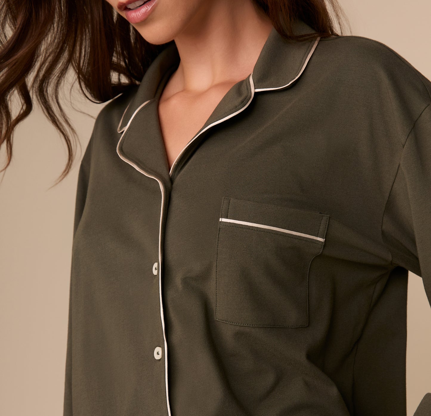 Close-up of the chest pocket and collar on the Perfect Pima Long Sleeve Pajama Shirt in Olive. White piping outlines the collar and pocket opening.