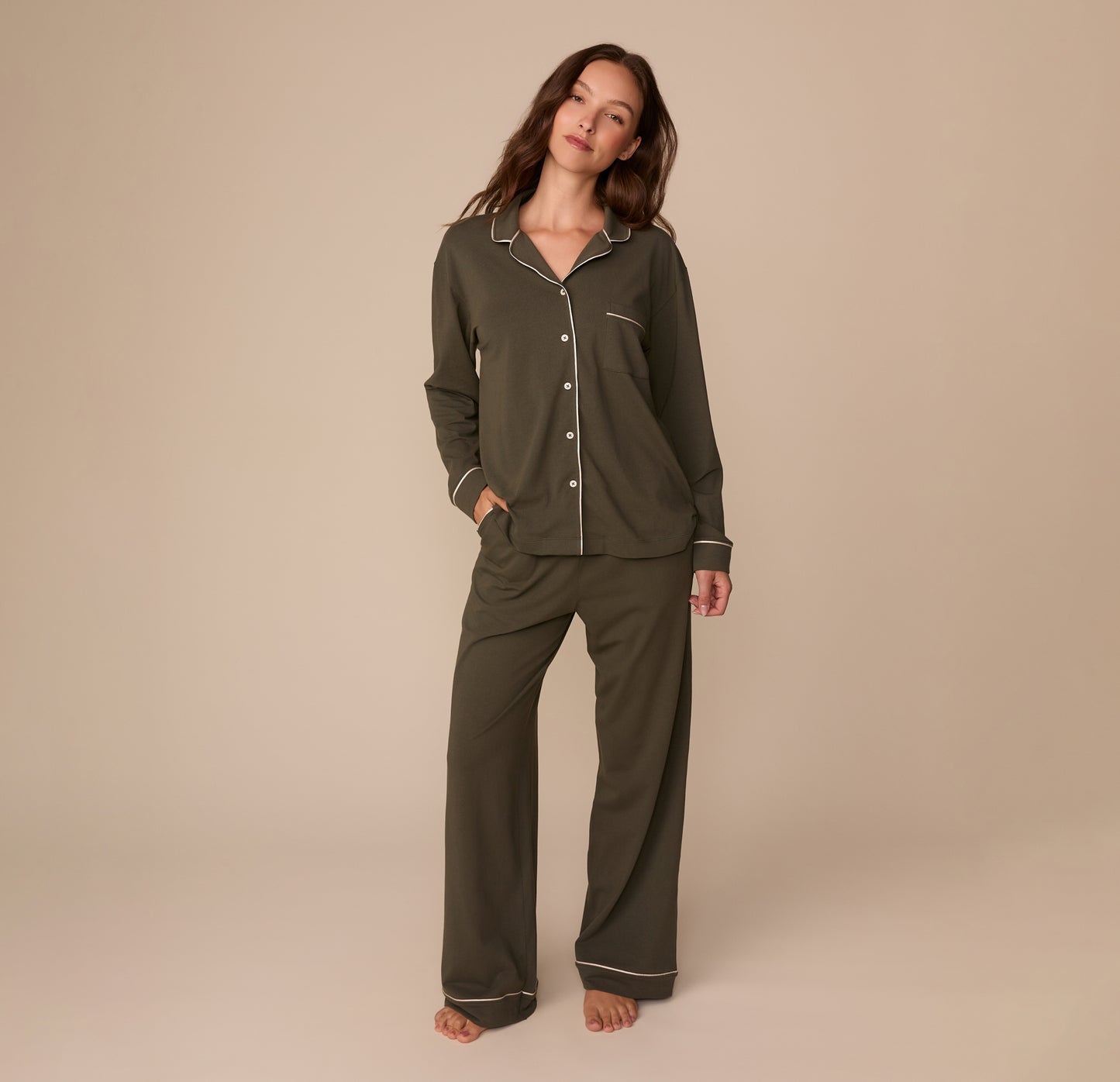 Full-body view of model Alexis in the Perfect Pima Long Sleeve Pajama Shirt and Pants in Olive. She stands barefoot with a soft smile, showing the full set’s relaxed, cozy fit.