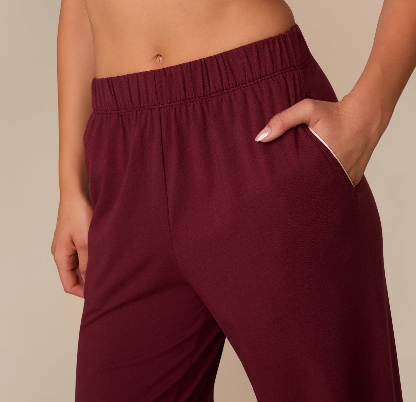 Close-up of the side pocket and waistband of the Perfect Pima Pajama Pants in Bordeaux. White piping lines the pocket opening.