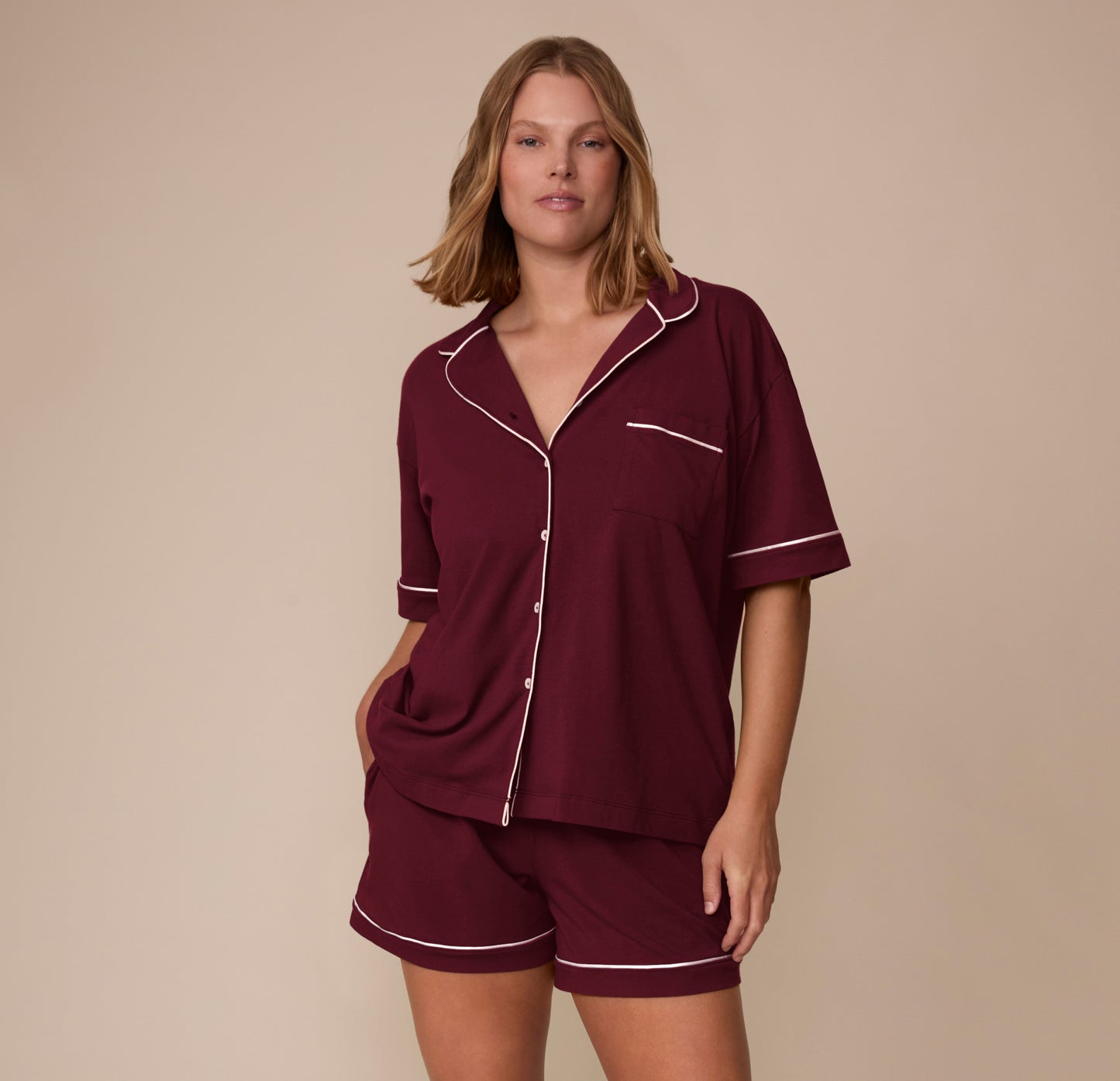 Full front view of model Sonnie wearing the Perfect Pima Pajama Shirt and Shorts in Bordeaux. The image showcases the full button front, relaxed sleeves, and matching pajama set.