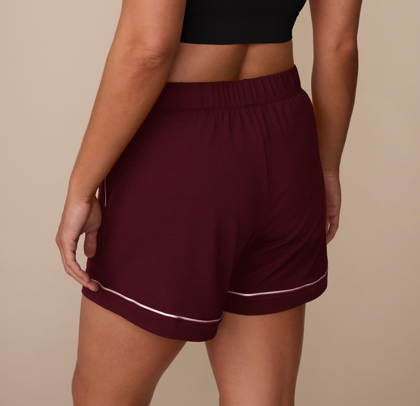 Rear view of model Sonnie in the Perfect Pima Pajama Shorts in Bordeaux. The image highlights the relaxed fit and soft drape of the Pima cotton fabric.