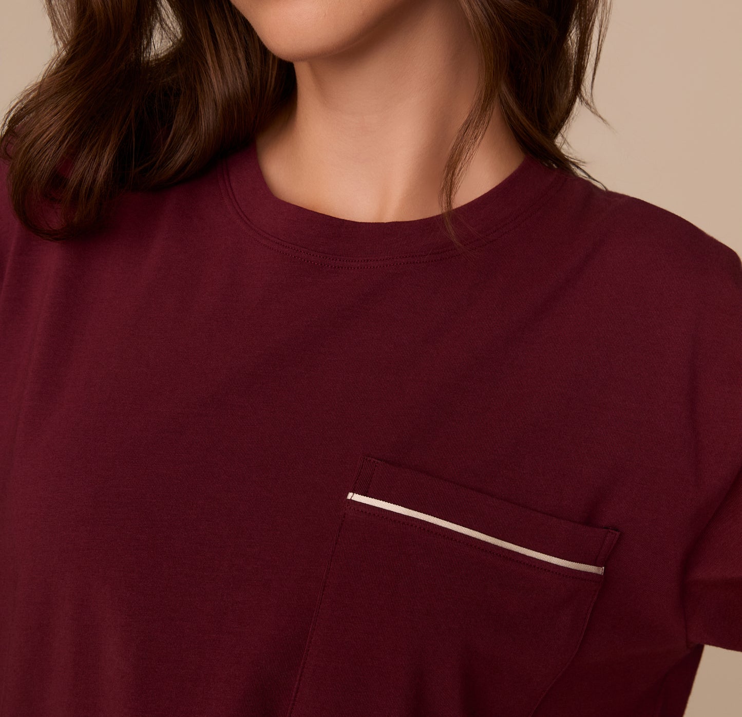 Close-up of the chest pocket on the Perfect Pima Pajama Tee in Bordeaux, highlighting the white contrast piping detail.
