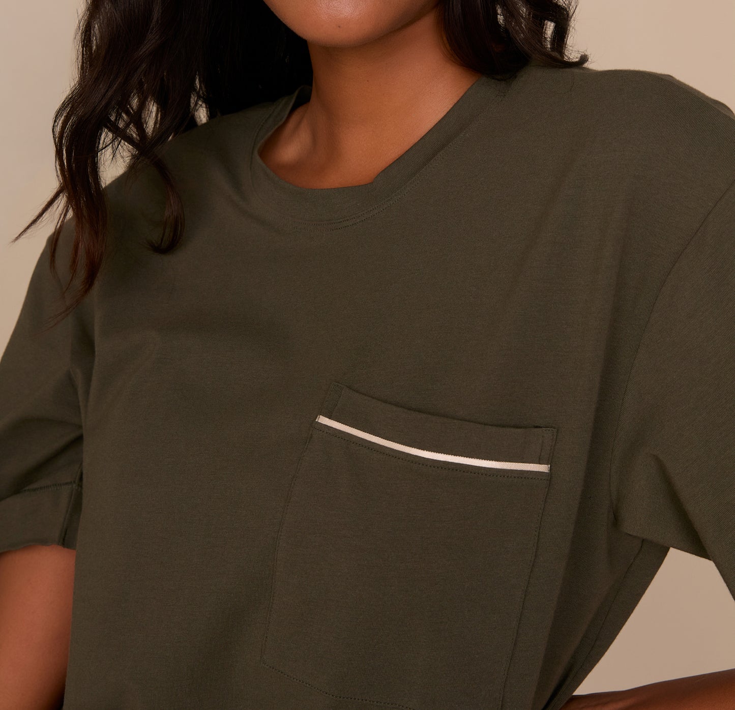 Close-up of the chest pocket on the Perfect Pima Pajama Tee in Olive, highlighting the white contrast piping and smooth Pima cotton fabric.