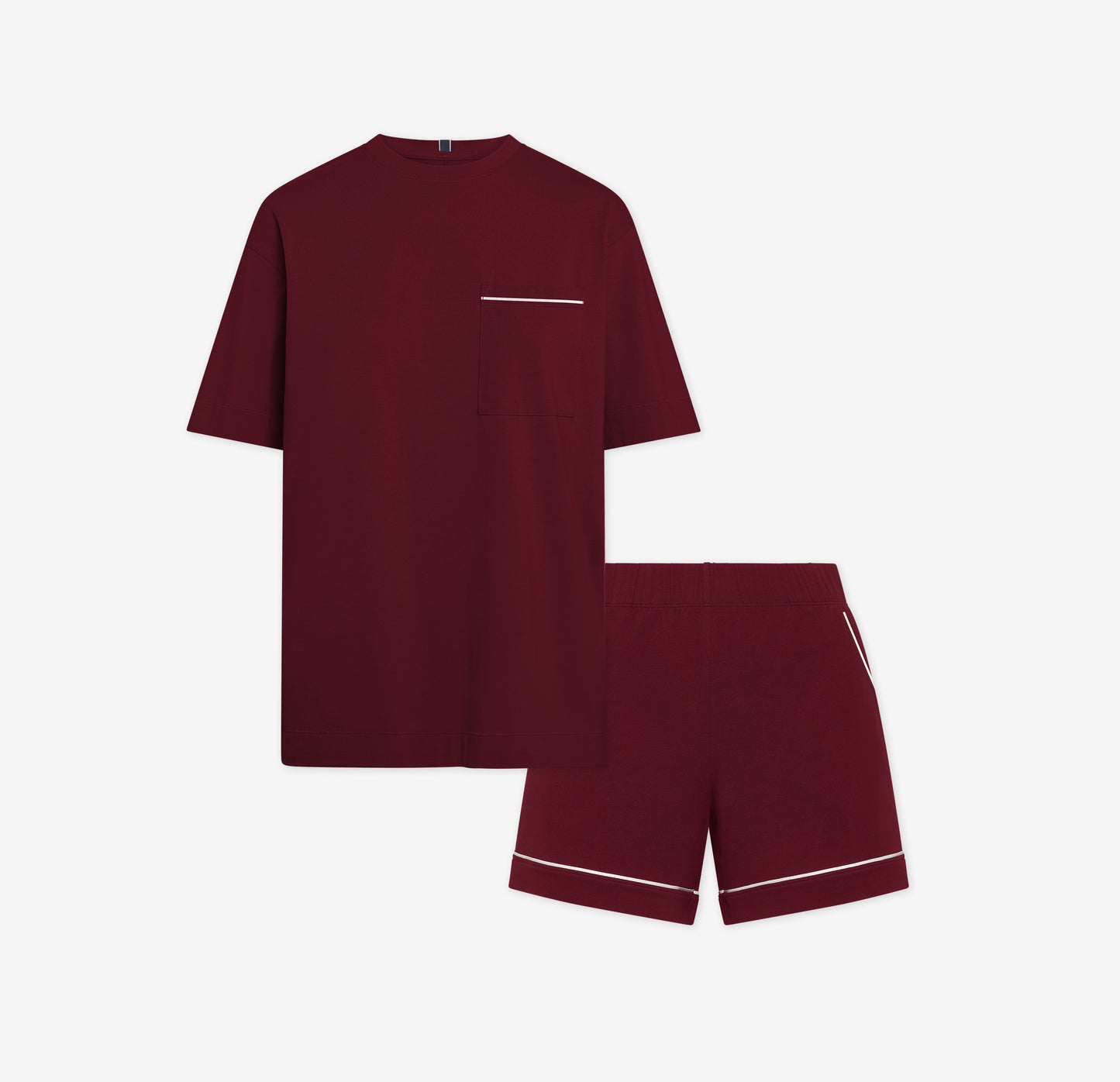 Harper Wilde Pima Pajama Set in Bordeaux. Includes relaxed fit tee with white chest pocket piping and matching pajama shorts. Set laid flat on a white background.