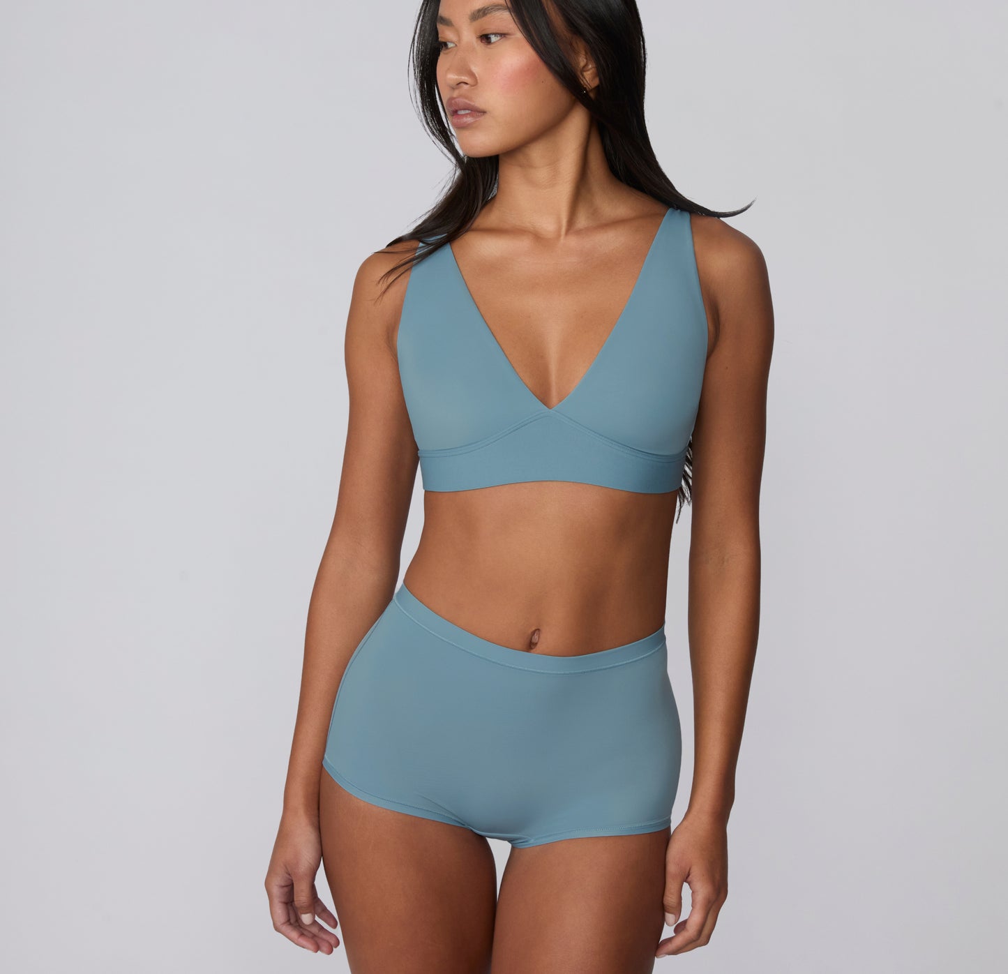 On a light gray studio backdrop, Amber wears the Bliss Boyshort in Poolside with a matching Bliss bralette. Shown in a three-quarter front view, the boyshort features a smooth waistband, full coverage through the hips, and soft microfiber fabric designed for comfortable, everyday wear with a no-show feel under clothing.