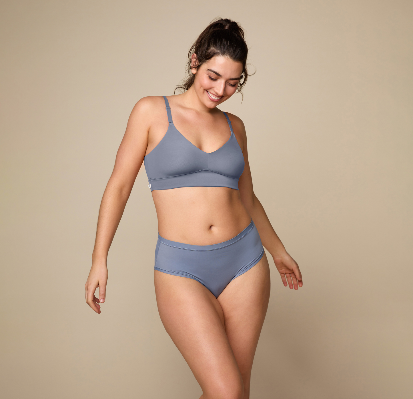 Woman wearing the Bliss Triangle Bralette in the color Steel. sizing: Kate wears size Large. Sizes L-6XL have higher center in front for additional support.