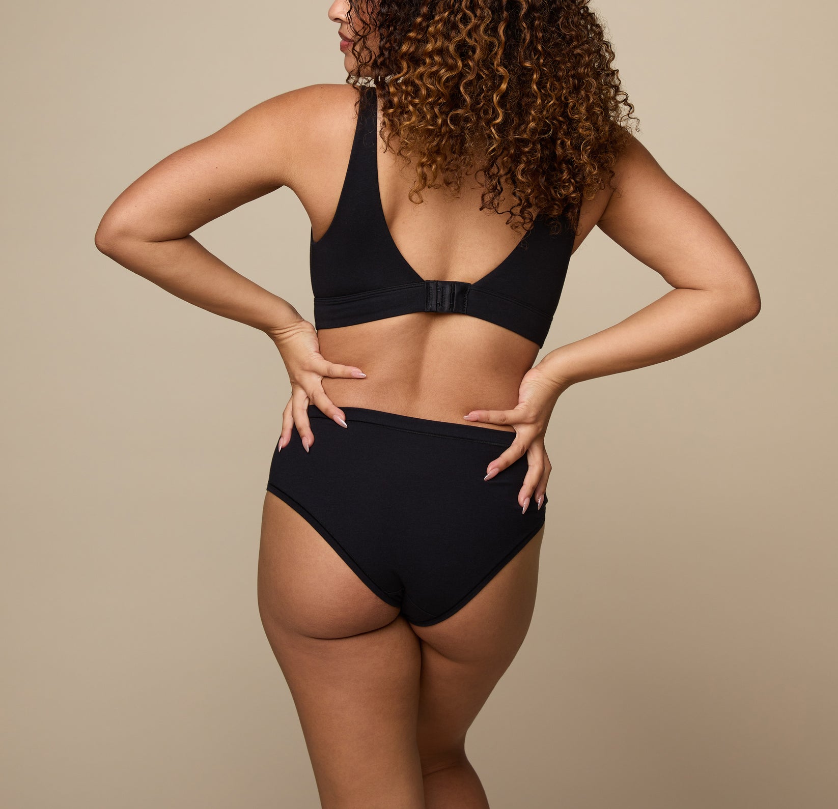 Woman wearing the Cloud Cotton Hiphugger underwear in the color Black