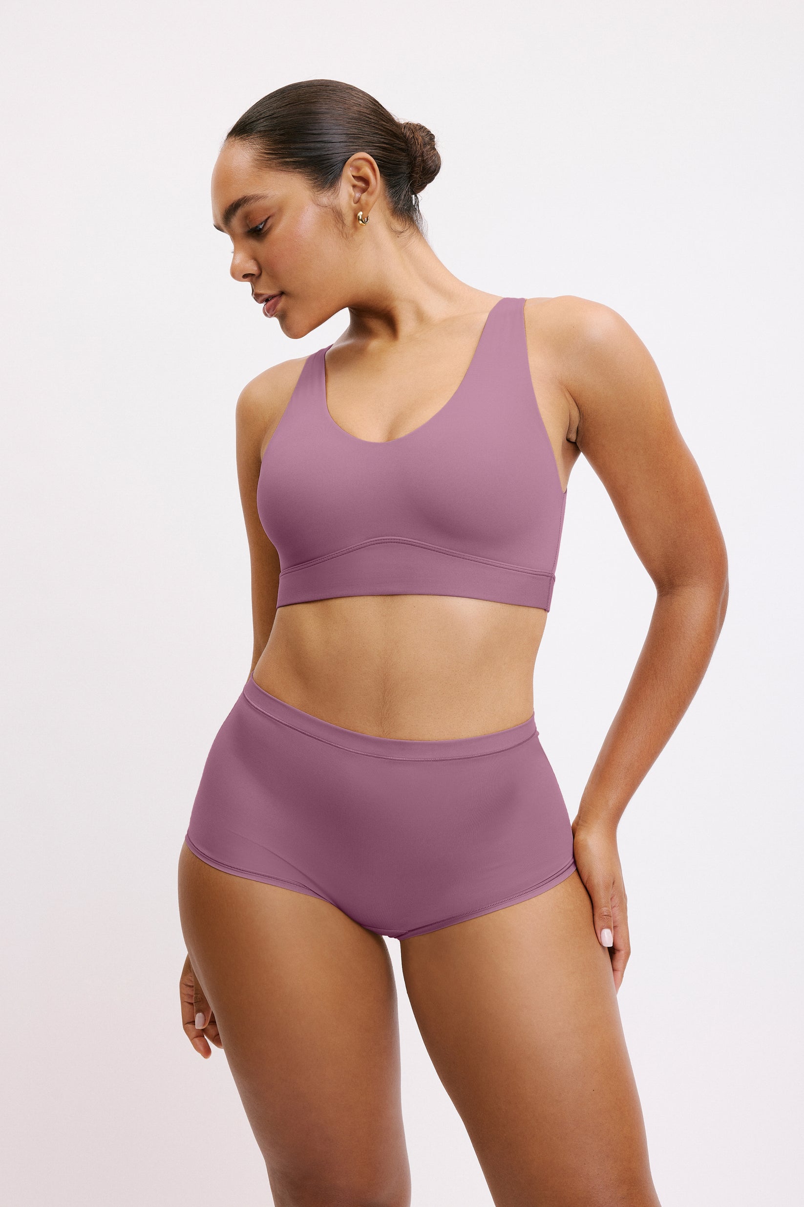 In a studio setting, Amber wears the Bliss Boyshort in Mirage with a matching bra, shown in a front-facing pose. The boyshort features a mid-rise fit, full coverage, and smooth, seamless fabric.