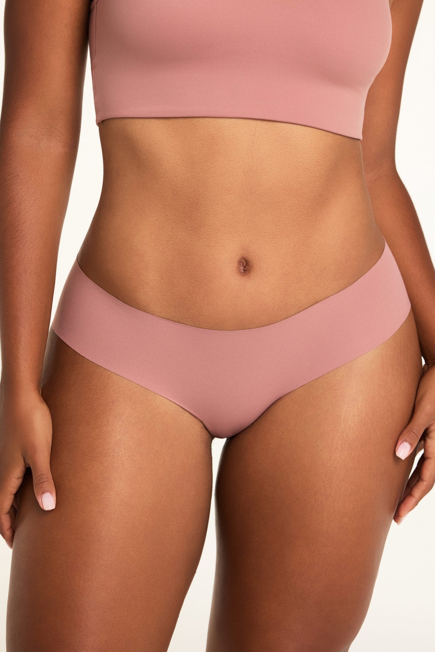 On a white studio backdrop, Amber wears the WhippedKnit Scoop and No-Show Hiphugger in Plum, shown in a close-up front view. sizing: Amber wears size Large
