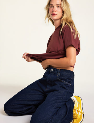 Editorial on-model shot of the Cloud Cotton T-Shirt in Cabernet styled with the Cloud Cotton Short in Cabernet.