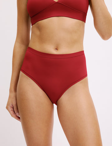 Three-quarter front view of the Bliss Highwaist Brief in Ruby paired with the Bliss Triangle Bralette in Ruby. sizing: Darion wears size Small