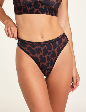 Front on-model shot of the Bliss Thong in Leopard paired with the Bliss Triangle Bralette in Leopard. sizing: Holly wears size  Small