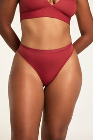 Front on-model shot of the Bliss Thong in Ruby paired with the Bliss Triangle Bralette in Ruby.