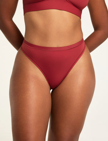 Front on-model shot of the Bliss Thong in Ruby paired with the Bliss Triangle Bralette in Ruby. sizing: Amber wears size Medium