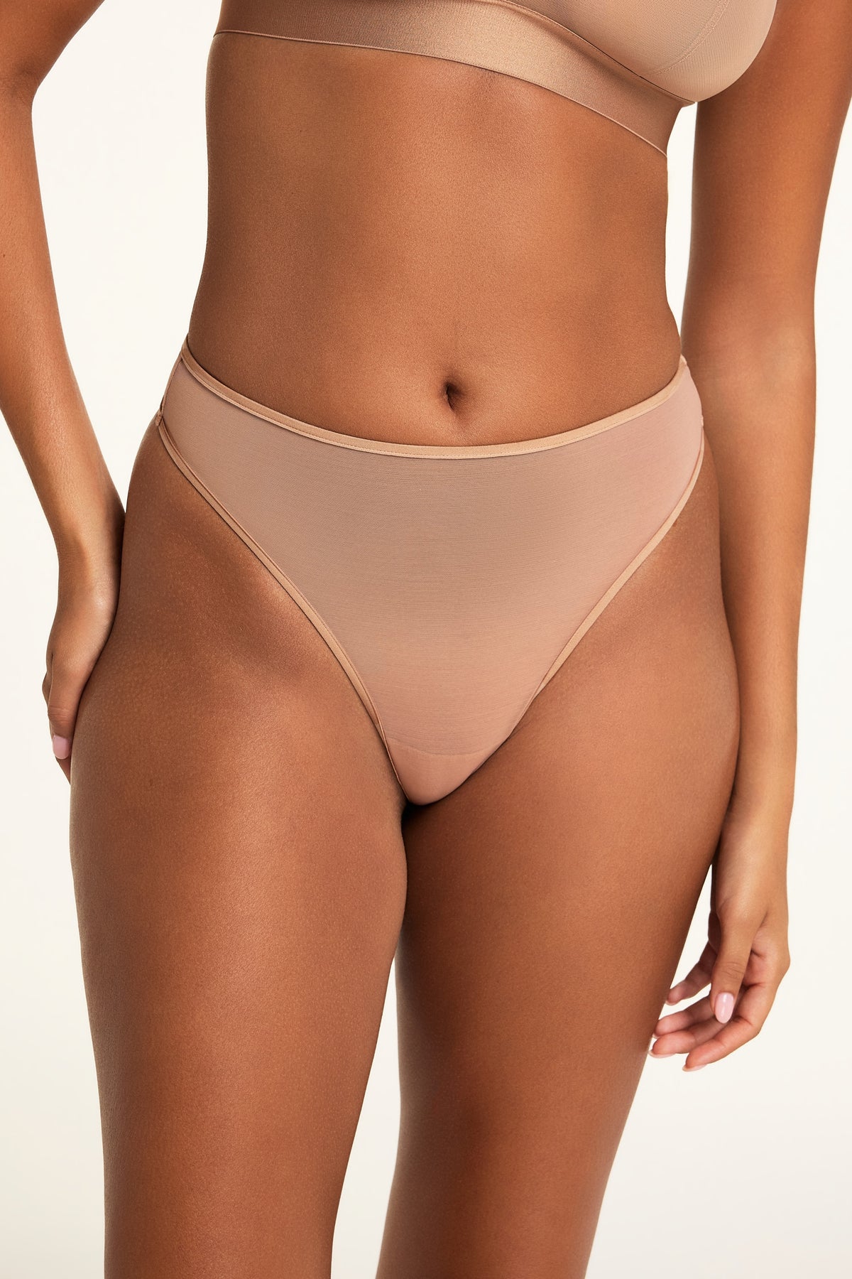 Front on-model shot of the ComfortMesh™ Thong in Taupe paired with the ComfortMesh™ Triangle Bralette in Taupe.