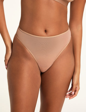Front on-model shot of the ComfortMesh™ Thong in Taupe paired with the ComfortMesh™ Triangle Bralette in Taupe. sizing: Kushi wears size XS 