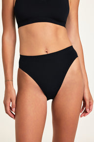 Front on-model shot of the Knit Seamless French Cut Brief in Black paired with the Knit Seamless Bralette in Black.