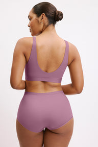In a studio setting, Amber wears the Bliss Boyshort in Mirage, shown from the back. The boyshort features full coverage with a smooth, seamless finish and clean edges.