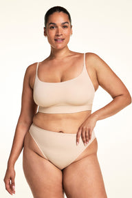 Full-length front view of the Bliss Thin-Strap Scoop Bralette in Beige.
