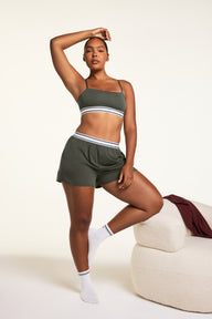 Editorial on-model shot of the Cloud Cotton Bandeau Bralette in Olive styled with the Cloud Cotton Short in Olive.