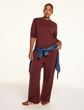Editorial on-model shot of the Cloud Cotton Long Sleeve T-Shirt in Cabernet styled with the Cloud Cotton Pant in Cabernet.